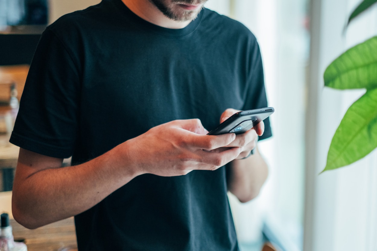 man holding smartphone with both hands